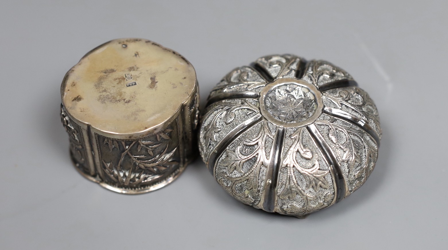 Two early 20th century Indian repousse white metal bowls, widest 12cm, a similar small dish and a salt.